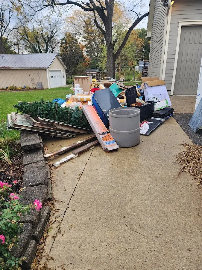 Dumpster being loaded with debris for Estate Cleanout Dumpster Rental in Sonora
